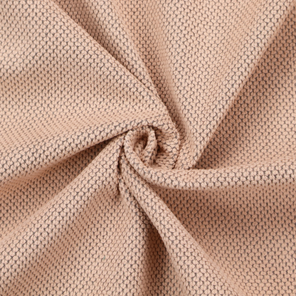 A waffle-knit or honeycomb-patterned weave, defined by a uniform, three-dimensional grid of raised, rounded textures. Its soft, warm peach or dusty rose hue and matte finish provide an elegant, cosy aesthetic. This structured, high-quality material is an excellent choice for luxury upholstery, decorative cushions, and premium home textiles that require a blend of durability and timeless style.