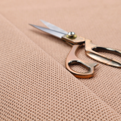 A waffle-knit or honeycomb-patterned weave, defined by a uniform, three-dimensional grid of raised, rounded textures. Its soft, warm peach or dusty rose hue and matte finish provide an elegant, cosy aesthetic. This structured, high-quality material is an excellent choice for luxury upholstery, decorative cushions, and premium home textiles that require a blend of durability and timeless style.