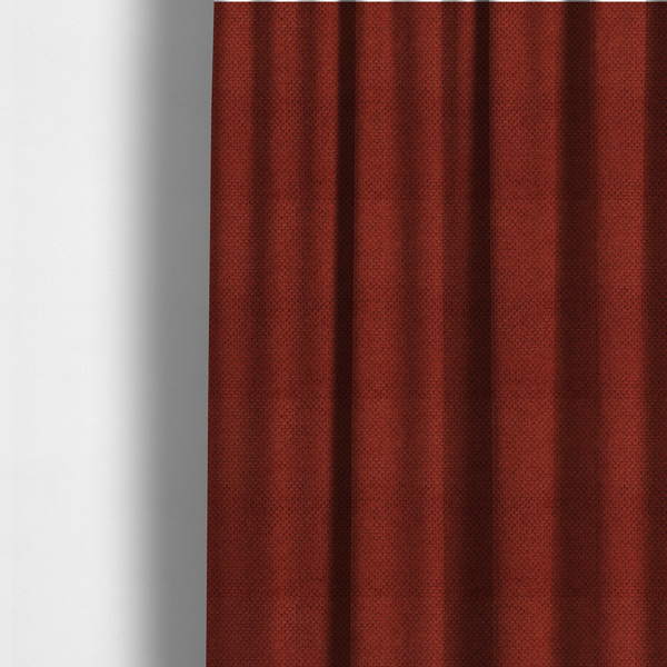 The fabric used to create these made-to-measure curtains is a waffle-knit or honeycomb-patterned weave, defined by a uniform, three-dimensional grid of raised, rounded textures. Its bold, warm terracotta or rust hue and matte finish provide a striking, cosy aesthetic. This structured, high-quality material is an excellent choice for statement upholstery, decorative accent cushions, or premium home textiles that require a blend of durability and timeless, earthy style.