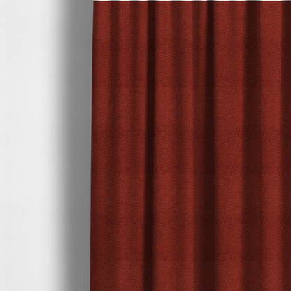 The fabric used to create these made-to-measure curtains is a waffle-knit or honeycomb-patterned weave, defined by a uniform, three-dimensional grid of raised, rounded textures. Its bold, warm terracotta or rust hue and matte finish provide a striking, cosy aesthetic. This structured, high-quality material is an excellent choice for statement upholstery, decorative accent cushions, or premium home textiles that require a blend of durability and timeless, earthy style.