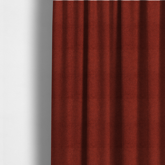 The fabric used to create these made-to-measure curtains is a waffle-knit or honeycomb-patterned weave, defined by a uniform, three-dimensional grid of raised, rounded textures. Its bold, warm terracotta or rust hue and matte finish provide a striking, cosy aesthetic. This structured, high-quality material is an excellent choice for statement upholstery, decorative accent cushions, or premium home textiles that require a blend of durability and timeless, earthy style.