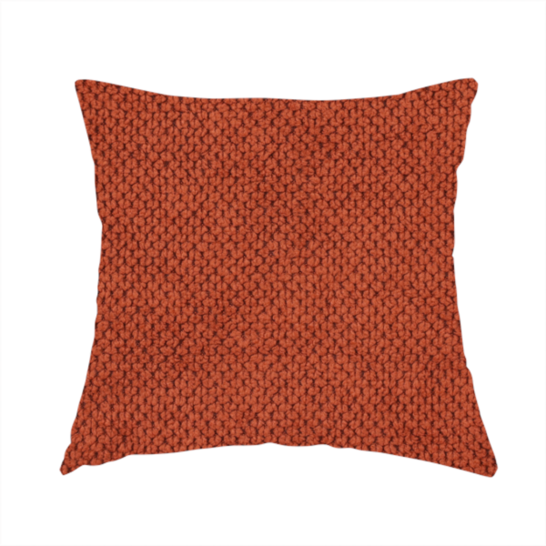 The fabric used to create these handmade cushions is a waffle-knit or honeycomb-patterned weave, defined by a uniform, three-dimensional grid of raised, rounded textures. Its warm, vibrant burnt orange or deep copper hue and matte finish provide a striking, cosy aesthetic. This structured, high-quality material is an excellent choice for statement upholstery, decorative accent cushions, or premium home textiles that require a blend of durability and timeless, rich style.