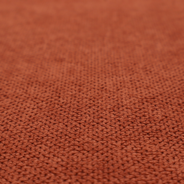 A waffle-knit or honeycomb-patterned weave, defined by a uniform, three-dimensional grid of raised, rounded textures. Its warm, vibrant burnt orange or deep copper hue and matte finish provide a striking, cosy aesthetic. This structured, high-quality material is an excellent choice for statement upholstery, decorative accent cushions, or premium home textiles that require a blend of durability and timeless, rich style.