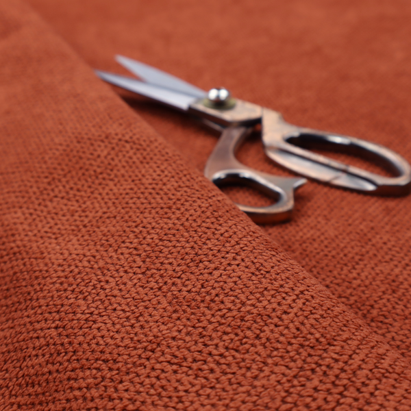 A waffle-knit or honeycomb-patterned weave, defined by a uniform, three-dimensional grid of raised, rounded textures. Its warm, vibrant burnt orange or deep copper hue and matte finish provide a striking, cosy aesthetic. This structured, high-quality material is an excellent choice for statement upholstery, decorative accent cushions, or premium home textiles that require a blend of durability and timeless, rich style.