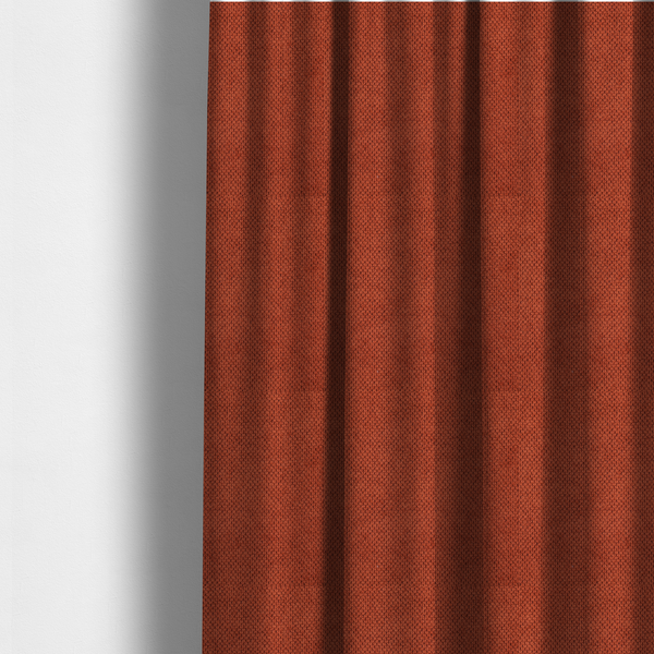 The fabric used to create these made-to-measure curtains is a waffle-knit or honeycomb-patterned weave, defined by a uniform, three-dimensional grid of raised, rounded textures. Its warm, vibrant burnt orange or deep copper hue and matte finish provide a striking, cosy aesthetic. This structured, high-quality material is an excellent choice for statement upholstery, decorative accent cushions, or premium home textiles that require a blend of durability and timeless, rich style.