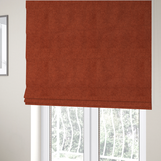 The fabric used to create these Roman blinds is a waffle-knit or honeycomb-patterned weave, defined by a uniform, three-dimensional grid of raised, rounded textures. Its warm, vibrant burnt orange or deep copper hue and matte finish provide a striking, cosy aesthetic. This structured, high-quality material is an excellent choice for statement upholstery, decorative accent cushions, or premium home textiles that require a blend of durability and timeless, rich style.