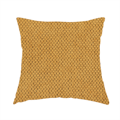The fabric used to create these handmade cushions is a waffle-knit or honeycomb-patterned weave of the collection, defined by its uniform, three-dimensional grid of raised, rounded textures. Its warm, vibrant mustard yellow or golden ochre hue, paired with a matte finish, provides a rich, inviting aesthetic. This structured, high-quality material is an excellent choice for statement upholstery, decorative accent cushions, or premium home textiles that require a blend of durability and timeless, cheerful sty