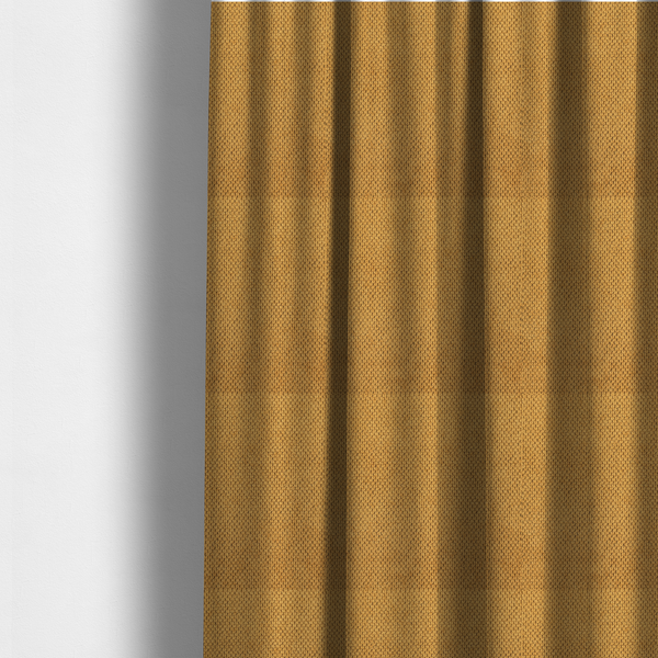 The fabric used to create these made-to-measure curtains is a waffle-knit or honeycomb-patterned weave of the collection, defined by its uniform, three-dimensional grid of raised, rounded textures. Its warm, vibrant mustard yellow or golden ochre hue, paired with a matte finish, provides a rich, inviting aesthetic. This structured, high-quality material is an excellent choice for statement upholstery, decorative accent cushions, or premium home textiles that require a blend of durability and timeless, cheer