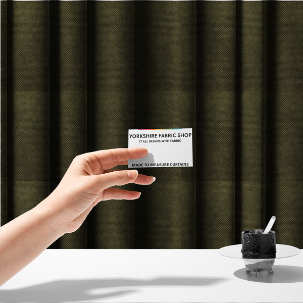 The fabric used to create these made-to-measure curtains is a waffle-knit or honeycomb-patterned weave of the collection, defined by its uniform, three-dimensional grid of raised, rounded textures. Its deep, rich forest green or dark olive hue and matte finish provide a sophisticated, moody, and grounded aesthetic. 