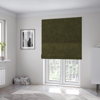 The fabric used to create these Roman blinds is a waffle-knit or honeycomb-patterned weave of the collection, defined by its uniform, three-dimensional grid of raised, rounded textures. Its deep, rich forest green or dark olive hue and matte finish provide a sophisticated, moody, and grounded aesthetic.