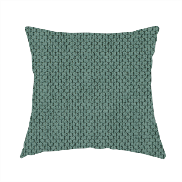 The fabric used to create this handmade cushion is a premium teal or seafoam green fabric with a structured, three-dimensional waffle-knit or honeycomb texture for elegant interior design.