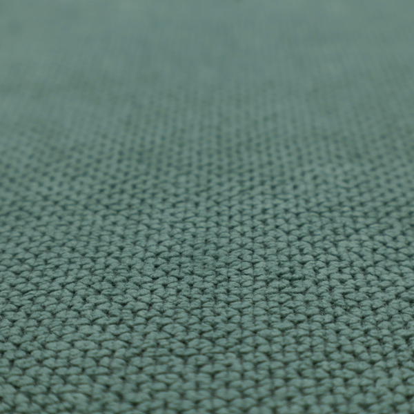 A premium teal or seafoam green fabric with a structured, three-dimensional waffle-knit or honeycomb texture for elegant interior design.