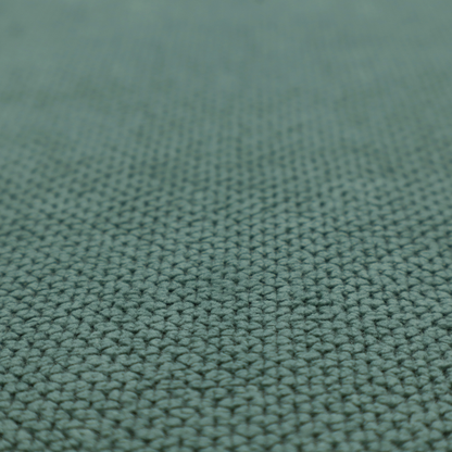 A premium teal or seafoam green fabric with a structured, three-dimensional waffle-knit or honeycomb texture for elegant interior design.