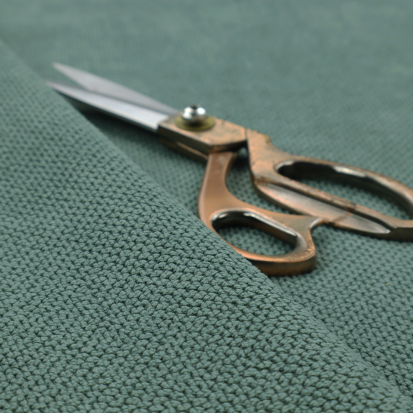 A premium teal or seafoam green fabric with a structured, three-dimensional waffle-knit or honeycomb texture for elegant interior design.