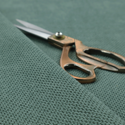 A premium teal or seafoam green fabric with a structured, three-dimensional waffle-knit or honeycomb texture for elegant interior design.