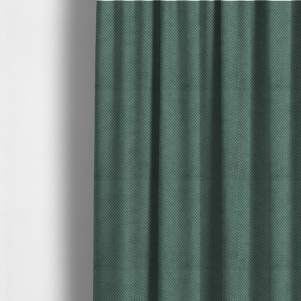 The fabric used to create these made-to-measure curtains is a premium teal or seafoam green fabric with a structured, three-dimensional waffle-knit or honeycomb texture for elegant interior design.