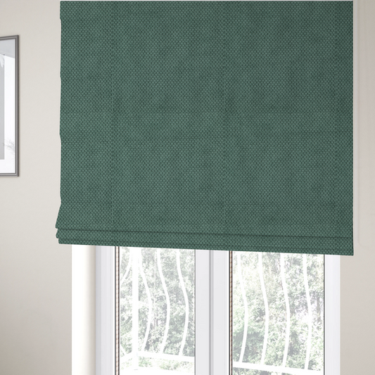 The fabric used to create these Roman blinds is a premium teal or seafoam green fabric with a structured, three-dimensional waffle-knit or honeycomb texture for elegant interior design.