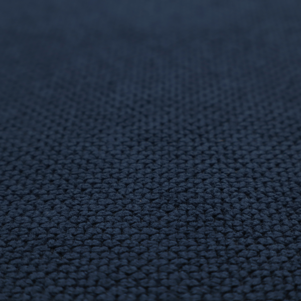 A premium deep navy blue waffle-knit fabric, highlighting a dense, three-dimensional honeycomb weave for luxury upholstery.