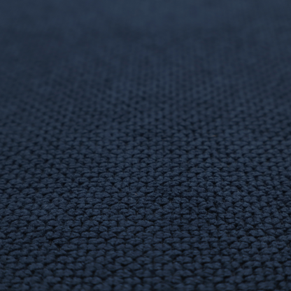 A premium deep navy blue waffle-knit fabric, highlighting a dense, three-dimensional honeycomb weave for luxury upholstery.