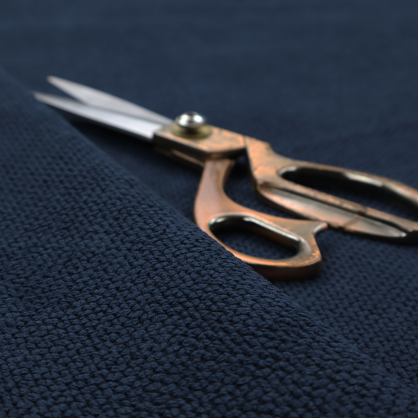 A premium deep navy blue waffle-knit fabric, highlighting a dense, three-dimensional honeycomb weave for luxury upholstery.