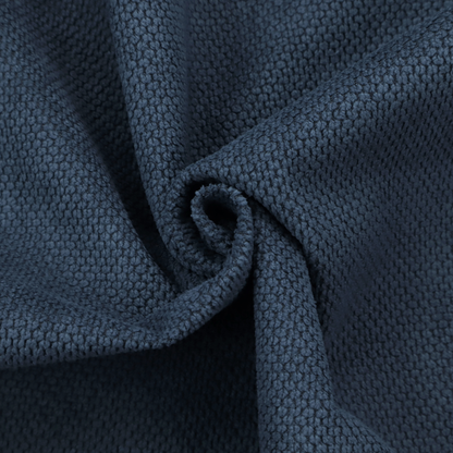 A premium navy blue waffle-knit fabric, highlighting a dense, three-dimensional honeycomb weave for luxury home decor.