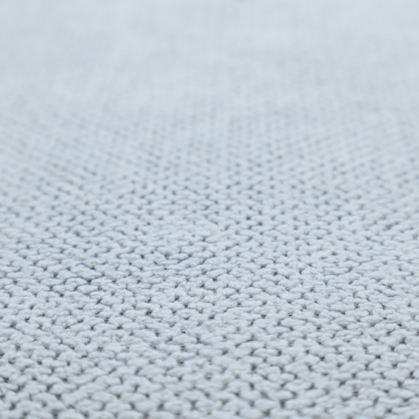 A premium pale ice blue waffle-knit fabric, showcasing a crisp, structured, and sophisticated honeycomb texture.