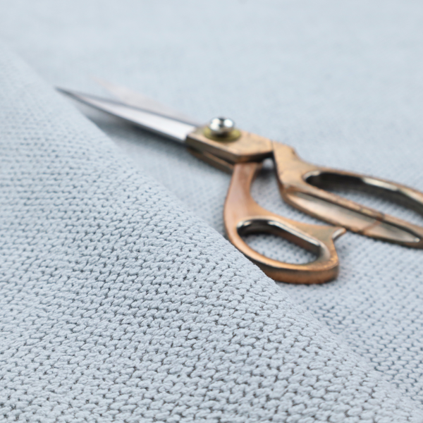 A premium pale ice blue waffle-knit fabric, showcasing a crisp, structured, and sophisticated honeycomb texture.