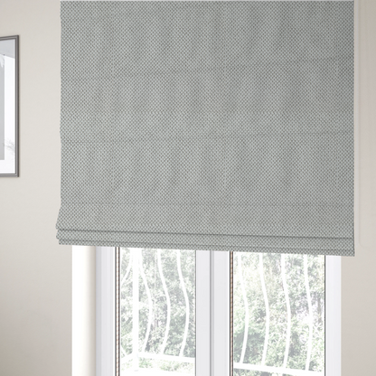 The fabric used to create these Roman blinds is a premium light grey or off-white waffle-knit fabric, featuring a crisp, structured, and sophisticated honeycomb texture.
