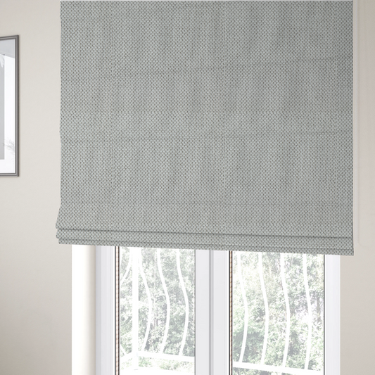 The fabric used to create these Roman blinds is a premium light grey or off-white waffle-knit fabric, featuring a crisp, structured, and sophisticated honeycomb texture.