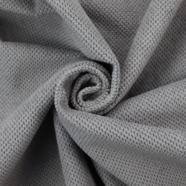 A light grey upholstery fabric. The material features a tightly woven, multidimensional texture that creates a soft, grainy appearance across the entire surface.
