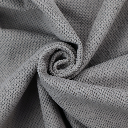 A light grey upholstery fabric. The material features a tightly woven, multidimensional texture that creates a soft, grainy appearance across the entire surface.