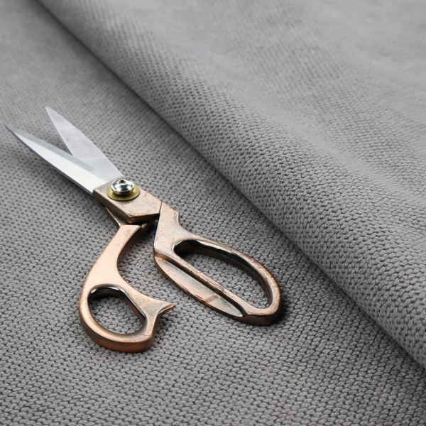 A light grey upholstery fabric. The material features a tightly woven, multidimensional texture that creates a soft, grainy appearance across the entire surface.