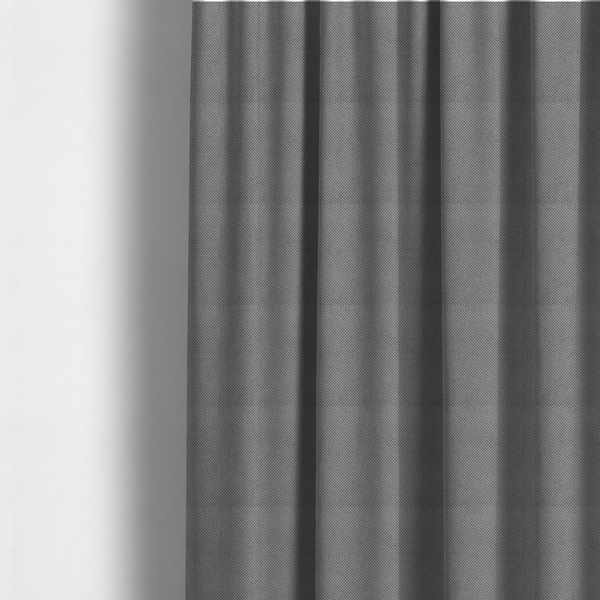 The fabric used to create these made-to-measure curtains is a light grey upholstery fabric. The material features a tightly woven, multidimensional texture that creates a soft, grainy appearance across the entire surface.