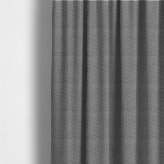 The fabric used to create these made-to-measure curtains is a light grey upholstery fabric. The material features a tightly woven, multidimensional texture that creates a soft, grainy appearance across the entire surface.
