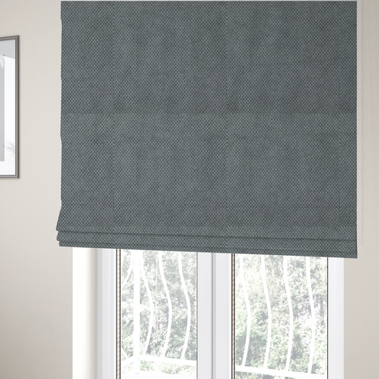 The fabric used to create these Roman blinds is a premium cool grey waffle-knit fabric, featuring a crisp, clean, three-dimensional honeycomb weave.