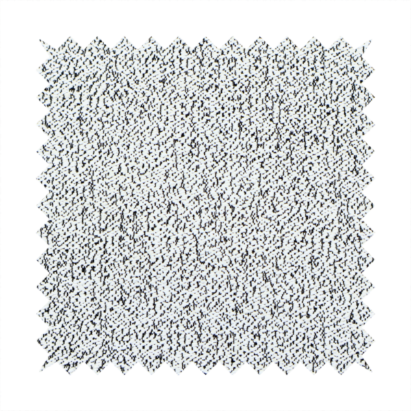 A textured white fabric with an intricate, irregular black speckled pattern throughout.