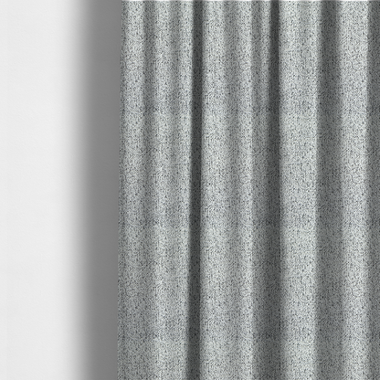 The fabric used to create these made-to-measure curtains is a textured white fabric with an intricate, irregular black speckled pattern throughout.