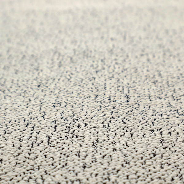 A cream-coloured textured fabric with a dense, irregular black speckled pattern.