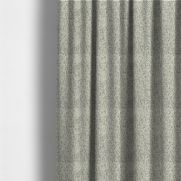The fabric used to create these made-to-measure curtains is a cream-coloured textured fabric with a dense, irregular black speckled pattern.