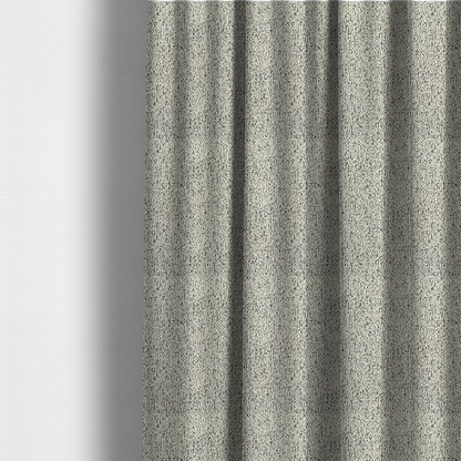 The fabric used to create these made-to-measure curtains is a cream-coloured textured fabric with a dense, irregular black speckled pattern.