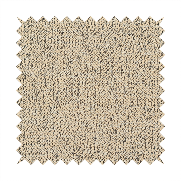 A beige textured fabric with a dense, irregular black speckled pattern.
