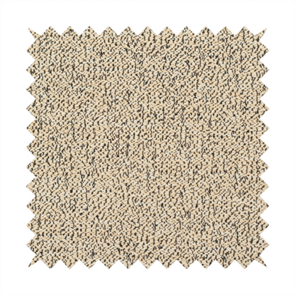 A beige textured fabric with a dense, irregular black speckled pattern.