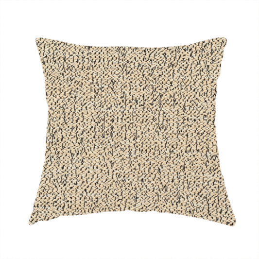 The fabric used to create these handmade cushions is a beige textured fabric with a dense, irregular black speckled pattern.