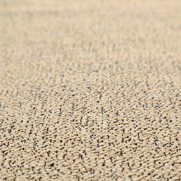 A beige textured fabric with a dense, irregular black speckled pattern.