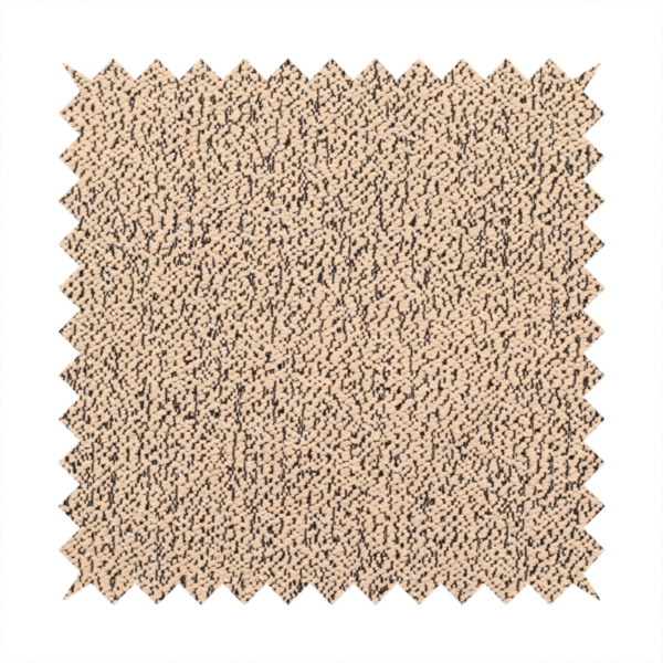 A tan textured fabric with a dense, irregular black speckled pattern.