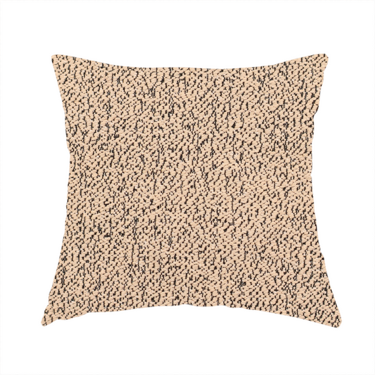 The fabric used to create these handmade cushions is a tan textured fabric with a dense, irregular black speckled pattern.