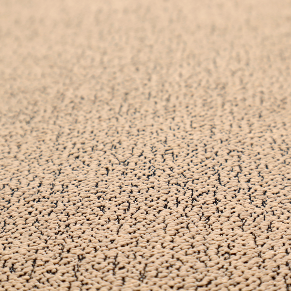 A tan textured fabric with a dense, irregular black speckled pattern.