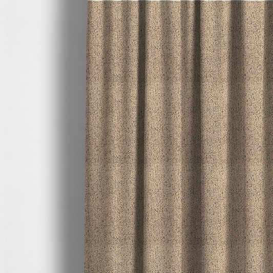 The fabric used to create these made-to-measure curtains is a tan textured fabric with a dense, irregular black speckled pattern.