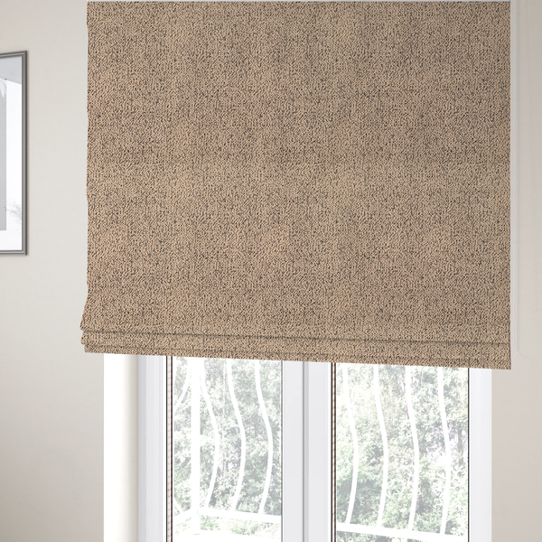 The fabric used to create these Roman blinds is a tan textured fabric with a dense, irregular black speckled pattern.