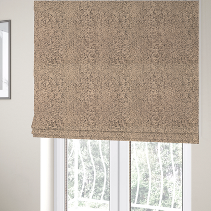 The fabric used to create these Roman blinds is a tan textured fabric with a dense, irregular black speckled pattern.